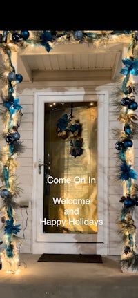 the front door of a home decorated for the holidays